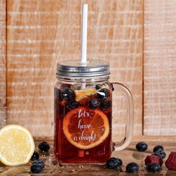 Ein großes Einmachglas mit Henkel, Metallschraubverschluss und Strohhalm ist mit einer roten Flüssigkeit, Blaubeeren, Himbeeren, einer Orangenscheibe und Eiswürfeln gefüllt. Auf dem Glas steht in weißer, kursiver Schrift 'let's - have a drink!'. Das Glas steht auf einer nassen Holzoberfläche, umgeben von weiteren Blaubeeren und einer halben Zitrone.